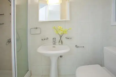 a bathroom with a sink and a toilet and a mirror at Ayios Elias Pearl in Protaras