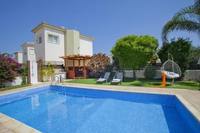 a swimming pool in front of a house at Villa Elias in Ayia Napa
