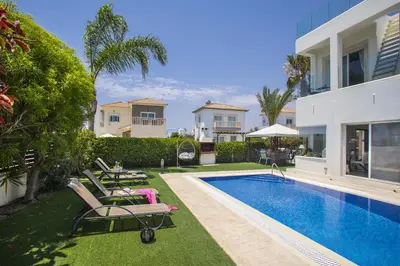 a villa with a swimming pool and a house at Villa Elias in Ayia Napa