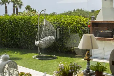 a bird sculpture sitting in the grass in a yard at Villa Elias in Ayia Napa