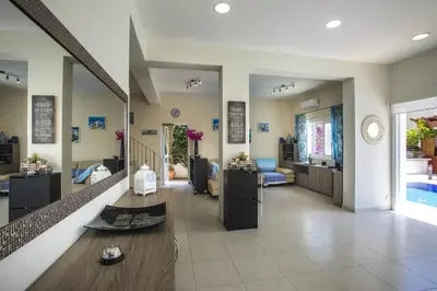 a living room with a couch and a dining room at Villa Elias in Ayia Napa