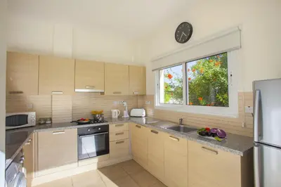 a kitchen with a sink and a window in it at Theodora in Protaras
