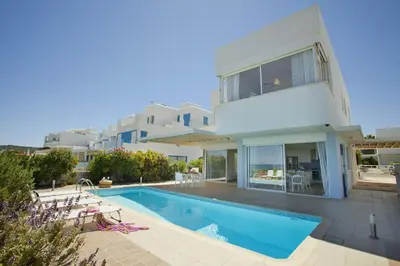 a villa with a swimming pool and a house at Protaras Seafront Villa Melissa in Protaras