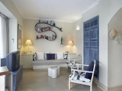 a living room with a couch and a tv at Protaras Nausicaa Villa Mykonos in Protaras