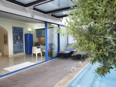 a living room with a pool in a house at Protaras Nausicaa Villa Mykonos in Protaras