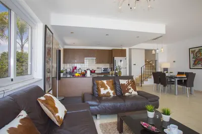 a living room with a couch and a table at Ayia Thekla Sea Front in Ayia Napa