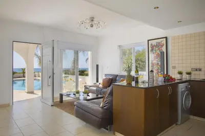 a living room with a couch and a table at Ayia Thekla Sea Front in Ayia Napa
