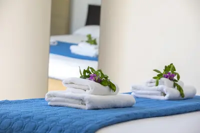 three towels with plants on top of them on a bed at Ayia Thekla Sea Front in Ayia Napa