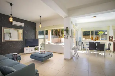 a living room with a couch and a table at Protaras Seaside Villa Michelle 10 in Protaras