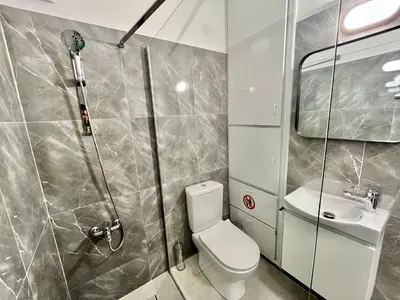 a bathroom with a shower and a toilet and a sink at Enaerios SeaView Studio in Limassol
