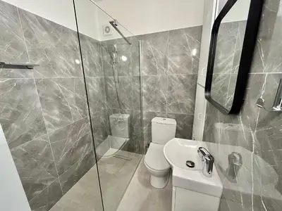 a bathroom with a toilet and a shower and a sink at Enaerios SeaView Studio in Limassol