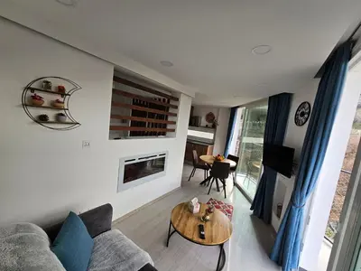 a living room with a couch and a table at THE CLIFF ALONA in Alona