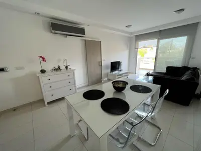 a living room with a white table and chairs at Majestic Boutique Apartment/2BR in Nicosia