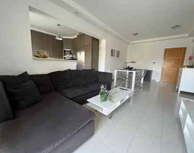 a living room with a brown couch and a table at Majestic Boutique Apartment/2BR in Nicosia