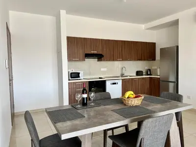 a kitchen with a table with a basket of fruit at Kings Boutique Apartment/2BR in Strovolos