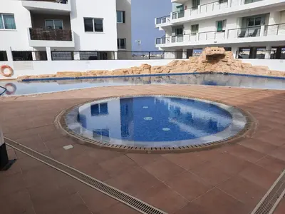 a large swimming pool in the middle of a building at Holiday Apartment with Sea View (0002913) in Paralimni
