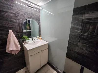 a bathroom with a sink and a mirror at Luxury Kalipso Beachfront in Limassol