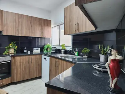 a kitchen with a statue of a woman on a counter at Luxury Kalipso Beachfront in Limassol