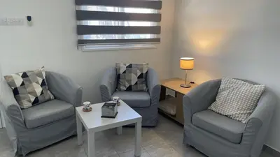 a living room with two chairs and a table at Villa Christo in Psematismenos