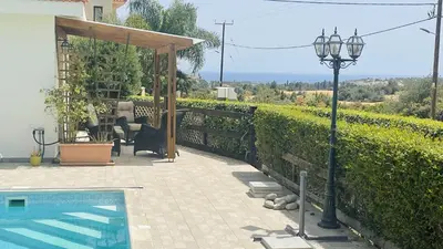 a house with a swimming pool and a street light at Villa Christo in Psematismenos