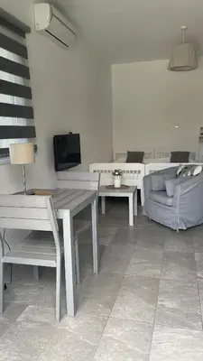 a living room with a table and a couch at Villa Christo in Psematismenos