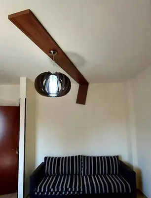 a living room with a couch and a ceiling light at Lakis Court in Larnaka