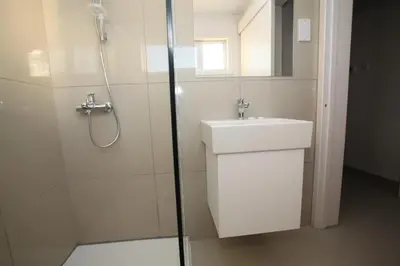 a bathroom with a shower and a sink and a shower at Boronia Hotel Apartments in Larnaka
