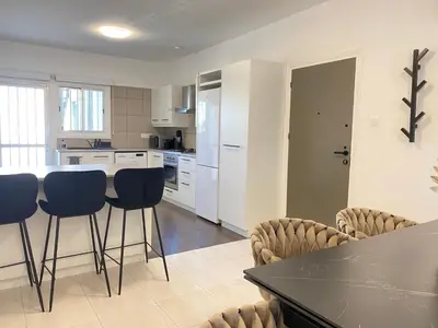 a kitchen with a table and chairs in a room at Central Boutique Twenty One in Nicosia