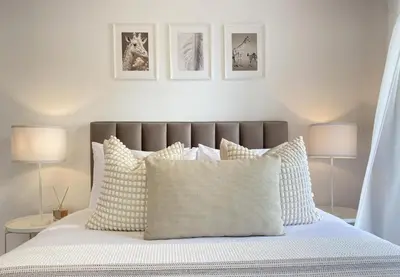 a bedroom with a bed with white pillows and two lamps at Central Boutique Twenty One in Nicosia