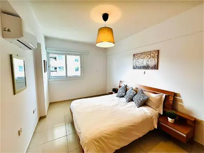 a bedroom with a large bed with pillows on it at Mackenzie 11 in Larnaka