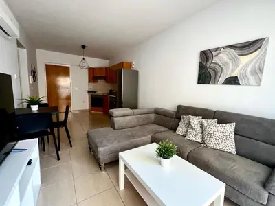 a living room with a couch and a table at Mackenzie 11 in Larnaka