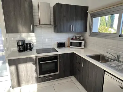 a kitchen with a sink and a stove top oven at Alasia Villa ll Kapparis in Paralimni