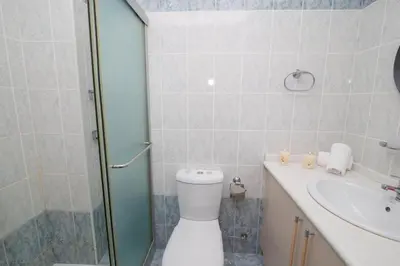 a bathroom with a shower and a toilet and a sink at The Good Times Apartment in Protaras