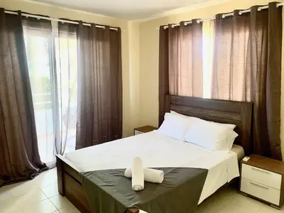 a bedroom with a bed with a white towel on it at Nissi 3 E8 Pool View Apt in Ayia Napa