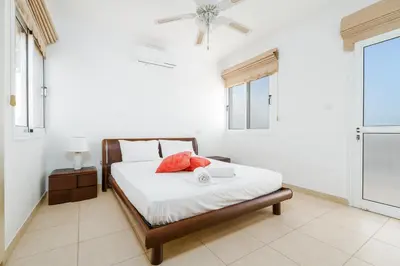 a bedroom with a bed and a ceiling fan at Spacious Villa with Private Pool & Breathtaking Panoramic Ayia Napa views in Ayia Napa