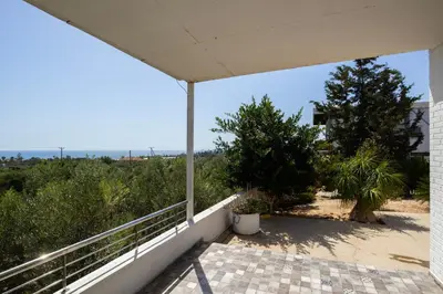 a balcony of a house with a view of the ocean at Captivating 2-Bed House in Alaminos