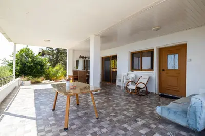 a living room with a table on a patio at Captivating 2-Bed House in Alaminos