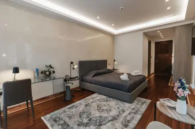 a bedroom with a bed and a table and a couch at 16 EXECUTIVE SUITES in Nicosia