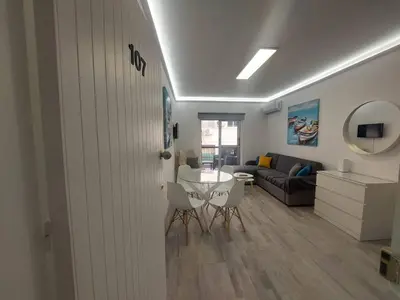 a living room with a table and a couch at AMAZING TWO BEDROOM APARTMENT in Ayia Napa