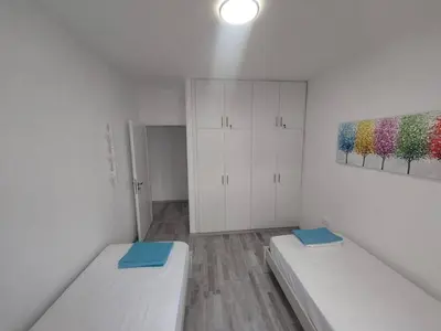 a room with two beds and a painting on the wall at AMAZING TWO BEDROOM APARTMENT in Ayia Napa