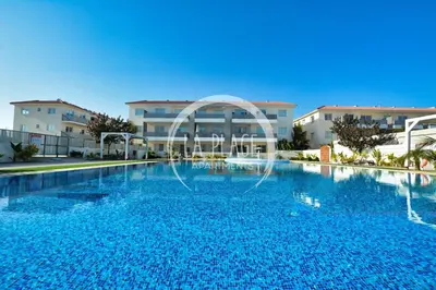 a large swimming pool in front of a building at Cozy 2 Bedroom Family Apartment w/ Pool in Protaras