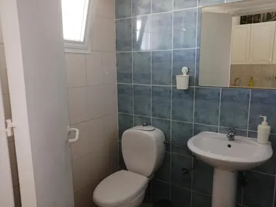 a small bathroom with a toilet and a sink at GALATEX BEACH STUDIO in Limassol