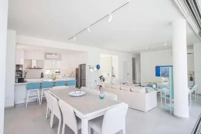 a dining room and kitchen with a table and chairs at Olivine Pearl OL3 in Protaras