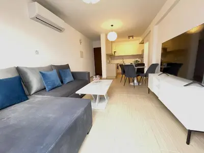 a living room with a couch and a table at Sunset Pearl Holiday Apt. - Ayia Napa in Ayia Napa