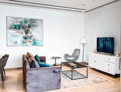a living room with a couch and a tv at 360 Nicosia Heights, Gym & Pool in Nicosia
