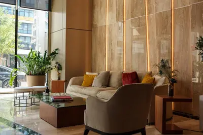 a living room with a couch and a glass table at 360 Nicosia Heights, Gym & Pool in Nicosia