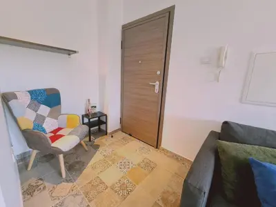 a living room with a chair and a door at STAY Kallipoleos Apartment in Nicosia