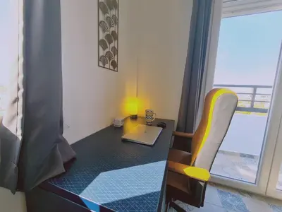 a room with a desk with a laptop and a chair at STAY Kallipoleos Apartment in Nicosia