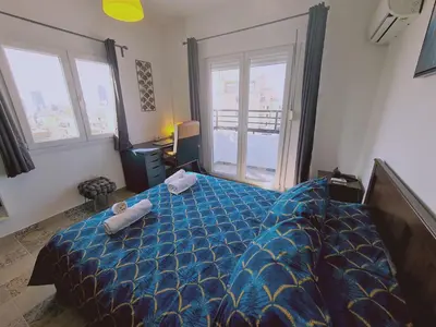 a bedroom with a blue bed with two towels on it at STAY Kallipoleos Apartment in Nicosia