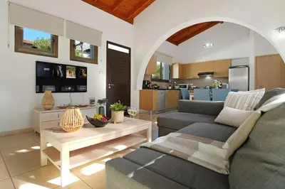 a living room with a couch and a table at Villa Anthia - 2bed with Large Pool in Ayia Napa